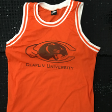  Orange sleeveless jersey shirt with black letters and logo.